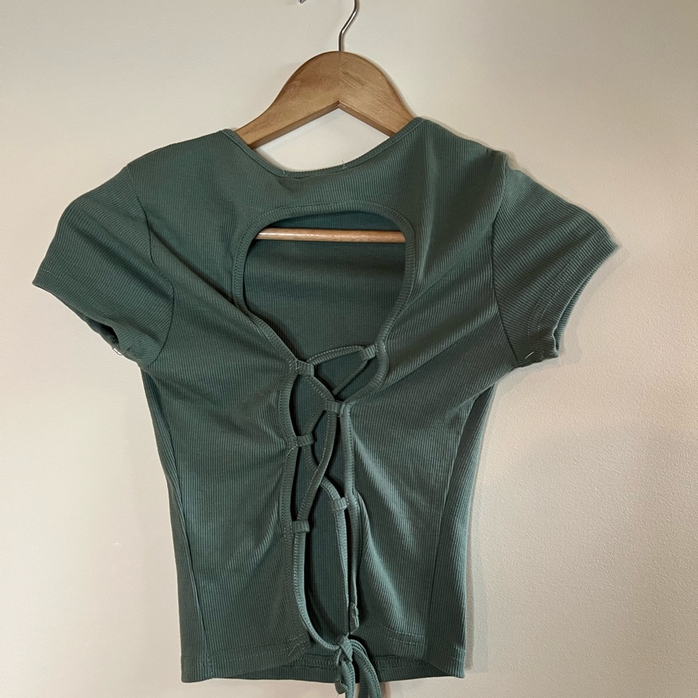 Green going out top with fun tie string back, cropped.